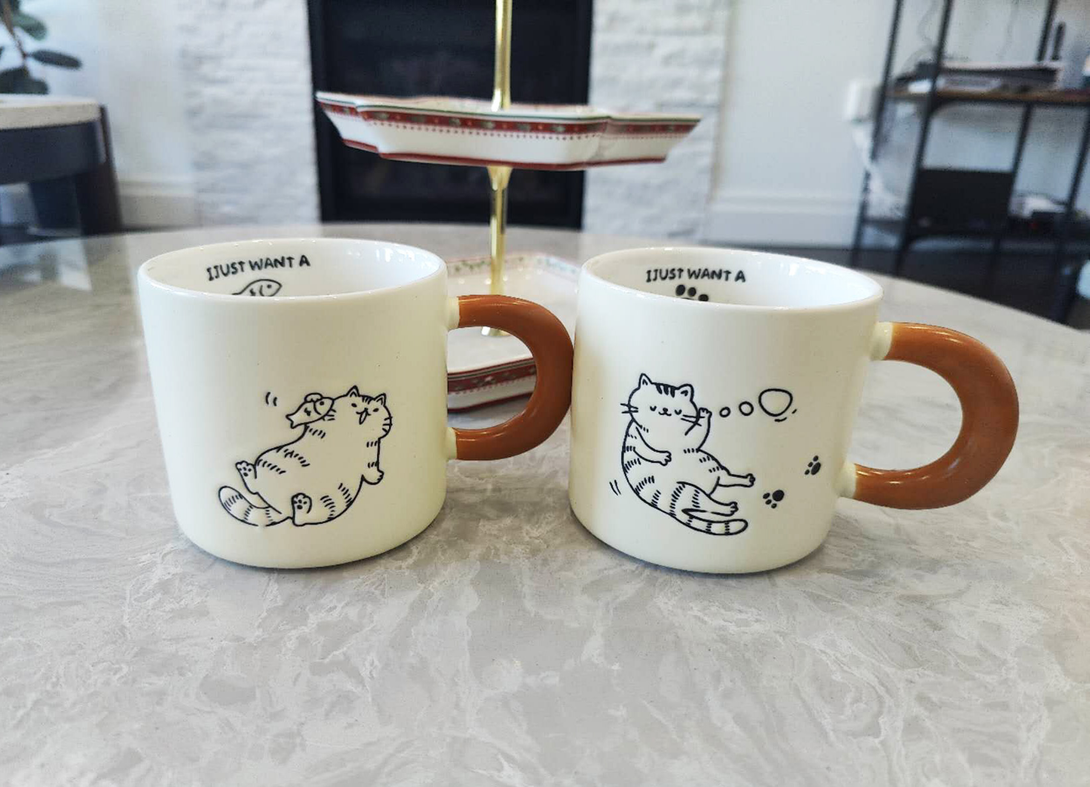 Cute Cartoon Kitty Coffee Cup - White mugs with brown handles featuring cat.