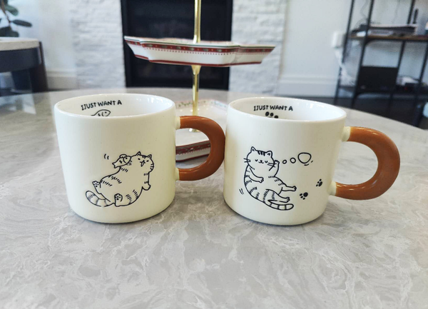 Cute Cartoon Kitty Coffee Cup - White mugs with brown handles featuring cat.