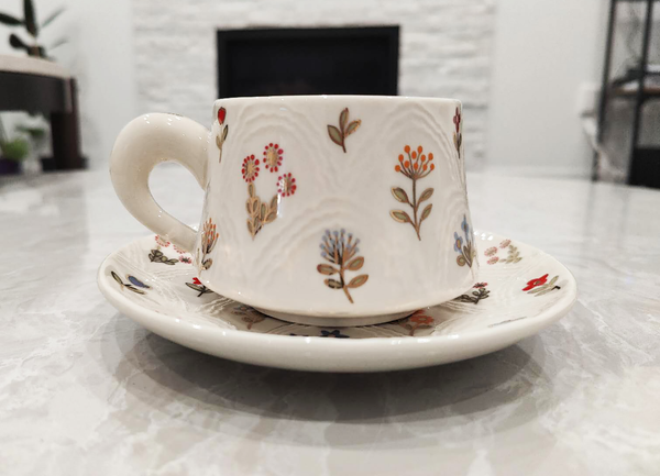 Golden Flower Cup Set |Relief Craft - Ceramic cup and saucer with floral design on a marble surface