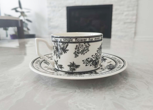Ink-Painting Bird Cup Set – Vintage Tea & Coffee Mug - Teacup and saucer with floral design and text on a light surface.